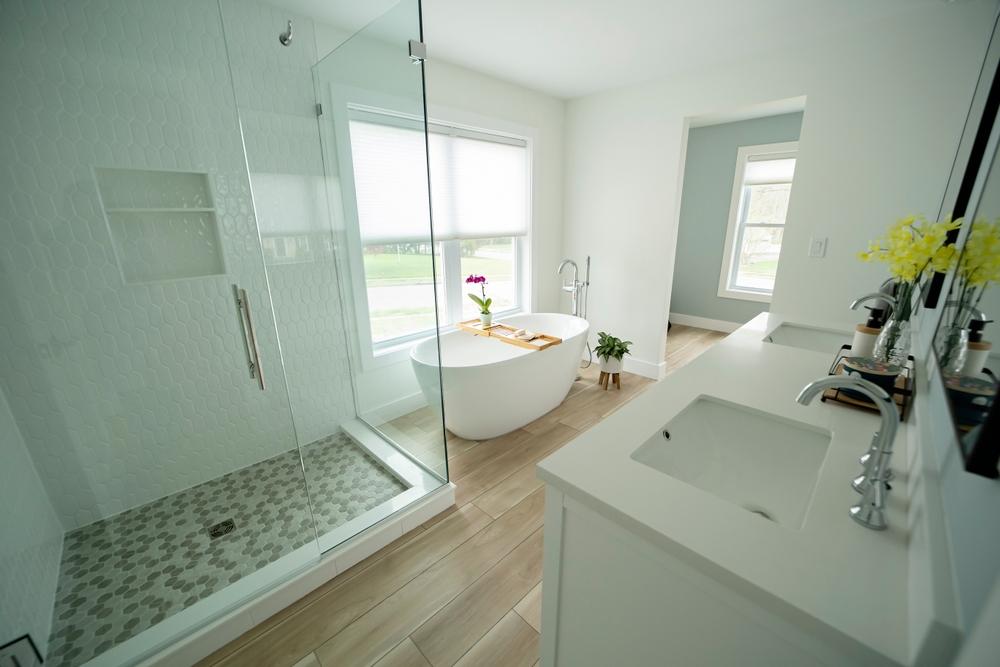 new bathroom remodel with white bath tub and counter tops
