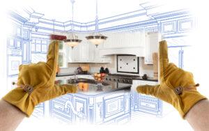kitchen with drawings and someone wearing construction gloves