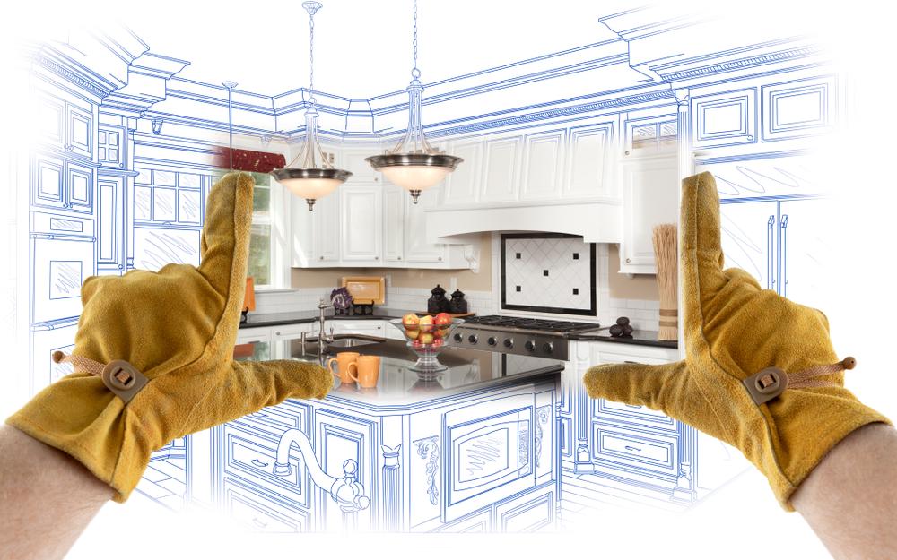 kitchen with drawings and someone wearing construction gloves