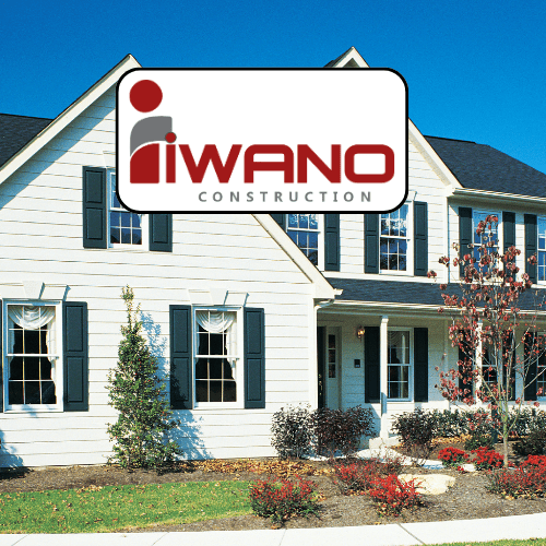 Iwano Construction logo in front of white suburban home
