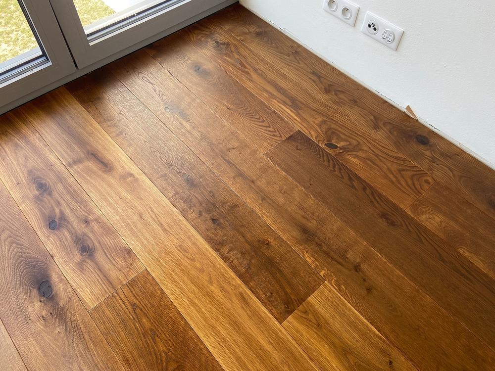 Empty white room with wooden floor. Close-Up View of Oak Wooden Flooring in an Empty Room.